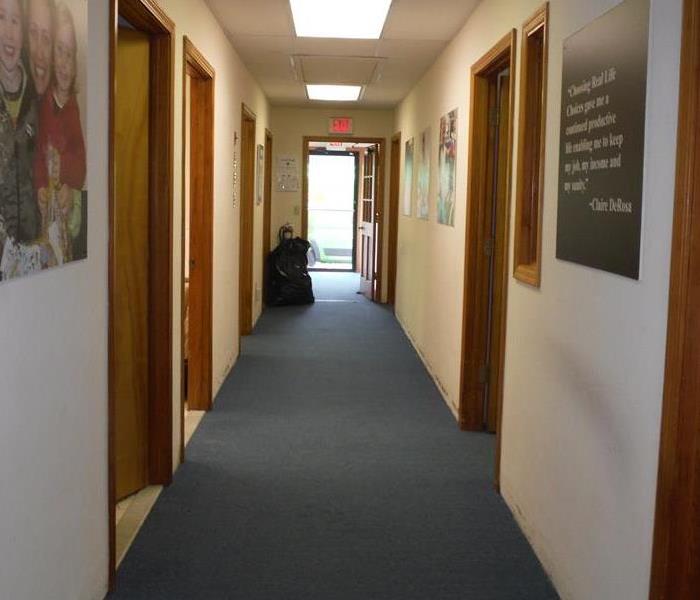 dry office hallway with blue carpet