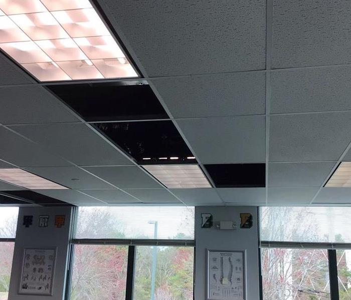 Commercial building with water damage dried and wet ceiling tiles removed