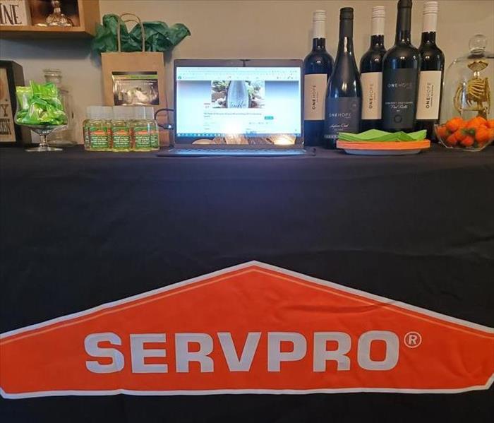 SERVPRO table set up with laptop displaying Virtual Fundraiser for Toms River Field of Dreams Event