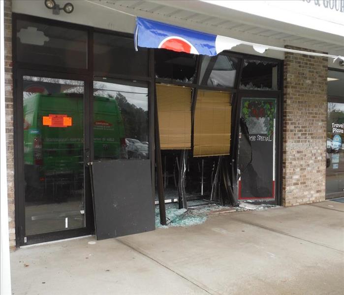 storefront of a shop with broken windows