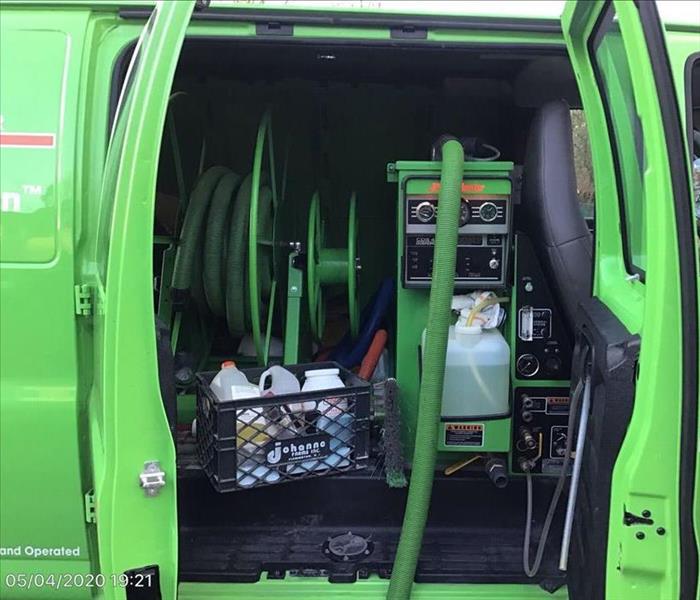 SERVPRO green fleet van with restoration services equipment inside