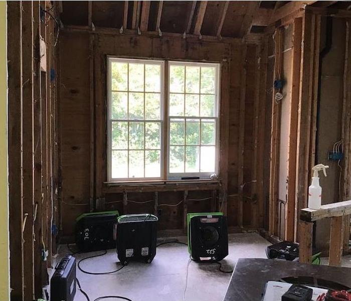  Room with studs and framework exposed with SERVPRO drying equipment