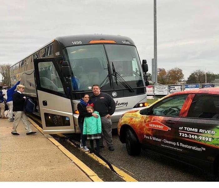 The Reilly Family standing by bus they rented to Donovan Catholic High School Football Team in Toms River 