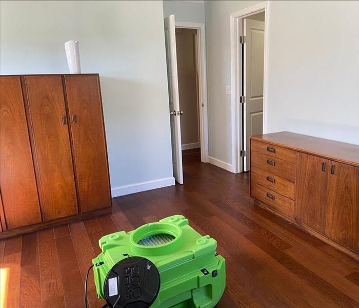 SERVPRO equipment on a hardwood floor in a bedroom