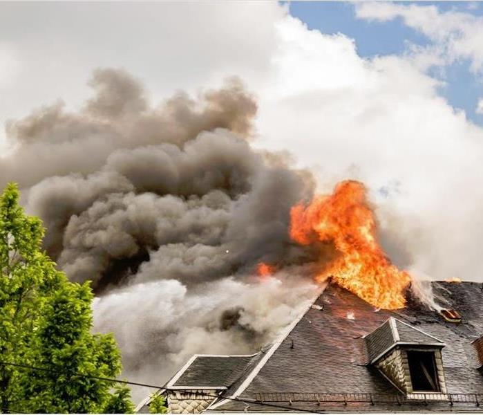 active fire raging on a roof of a home