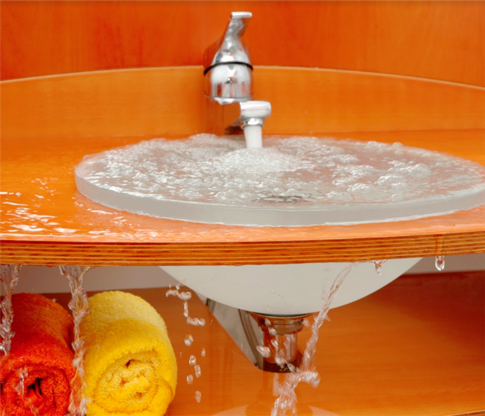 orange sink that is leaking water