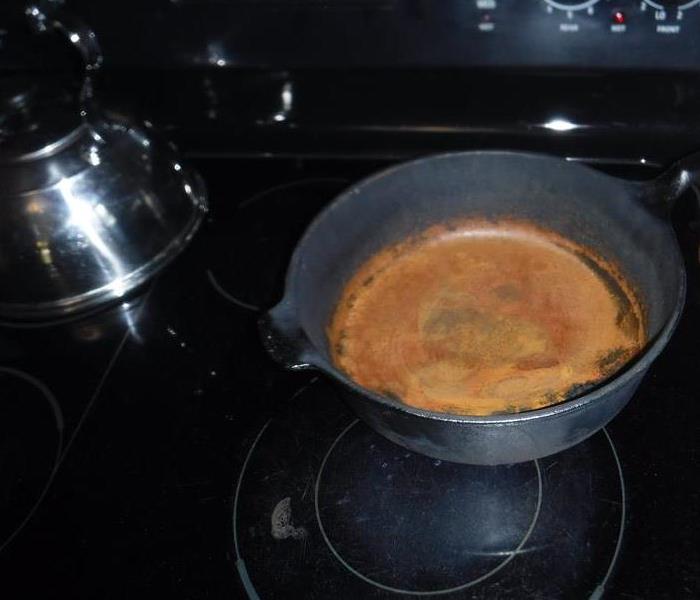 Grease fire in a cast iron pan on stovetop