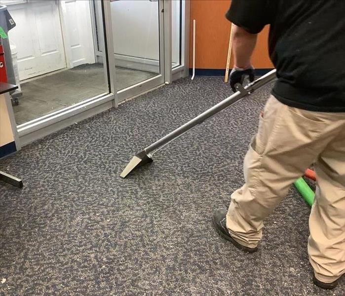SERVPRO of Toms River extracting water from the carpet of a business