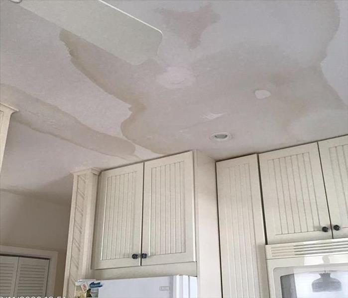 Kitchen ceiling with water damage stains